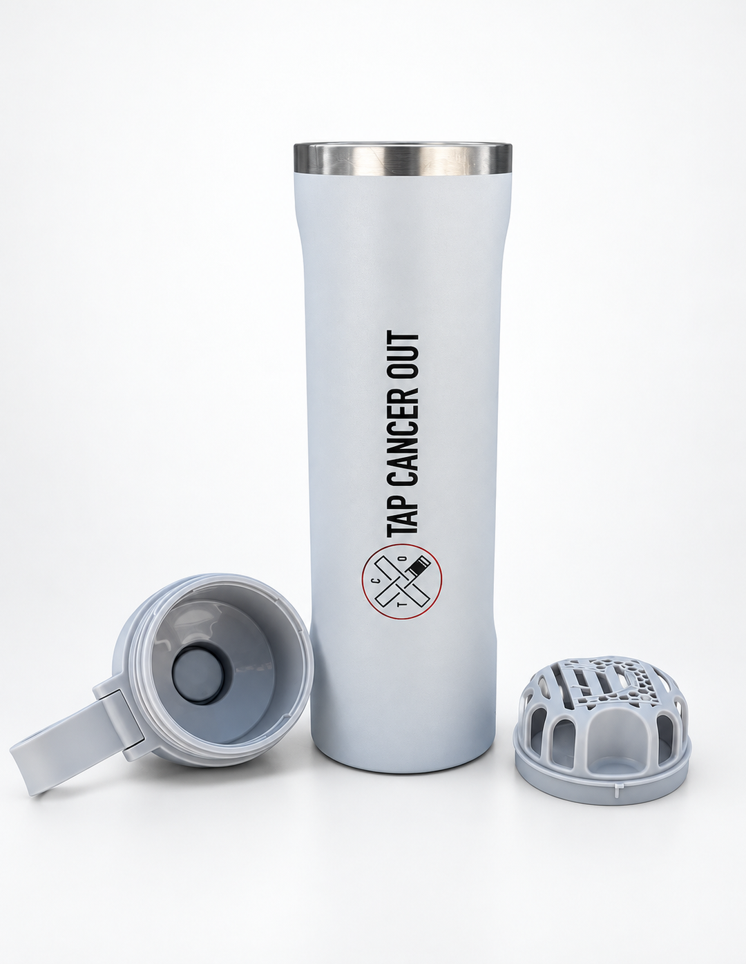 A light gray insulated travel tumbler with a stainless steel rim, featuring the black printed text 'TAP CANCER OUT' and a no-fire symbol. The tumbler is shown alongside two gray replacement lids, one lying on its side and the other standing upright, all set against a clean white background.